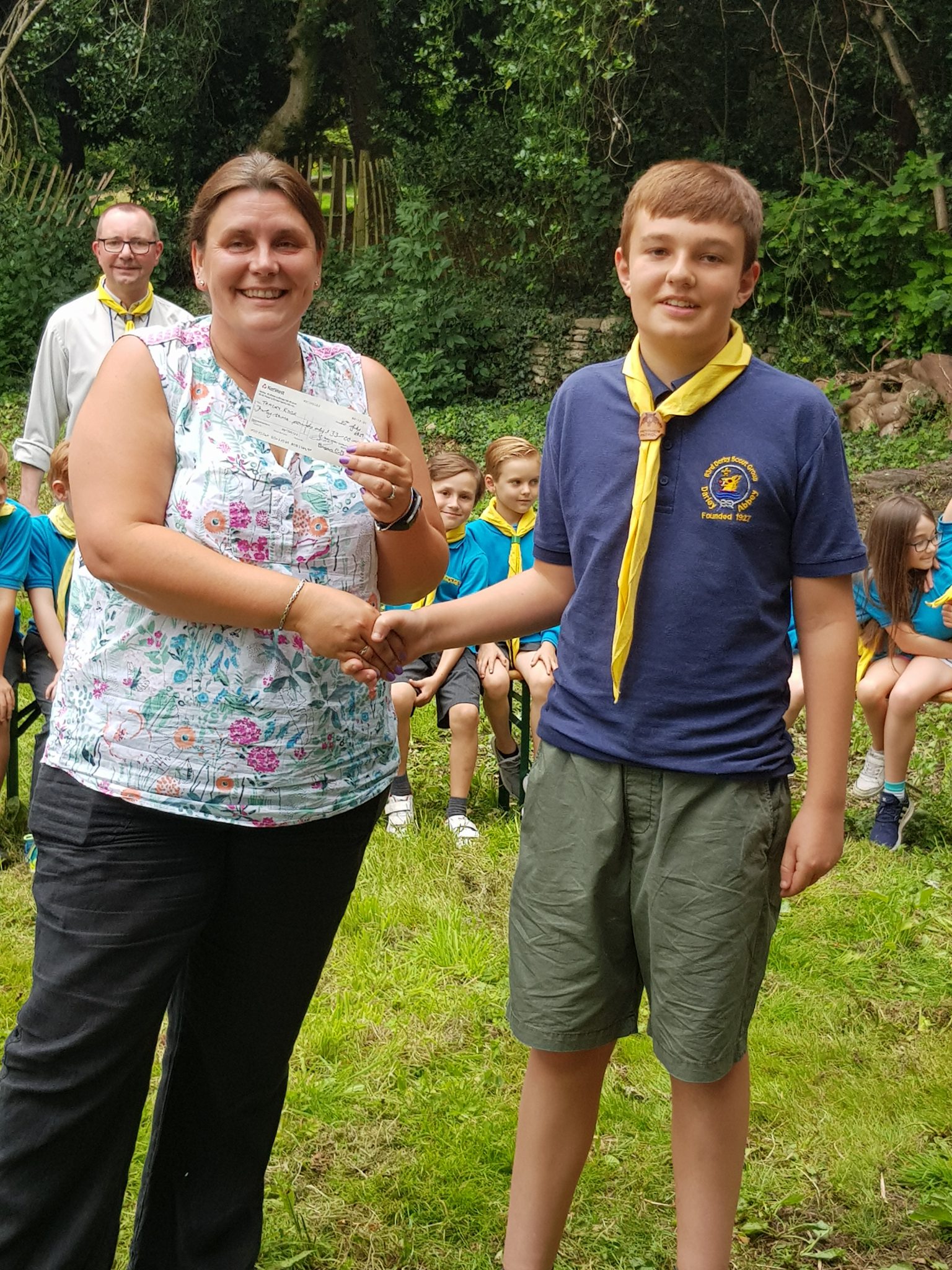 Ben presents a cheque to Tracey who won the June 2019 draw
